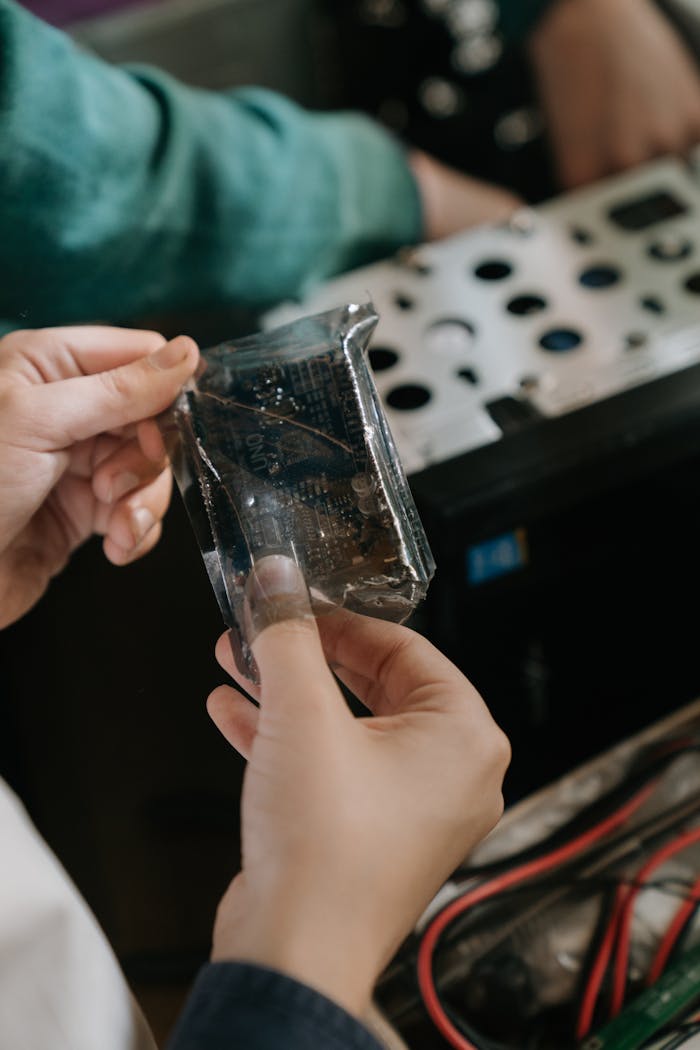 Person Holding Clear Glass Container